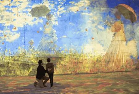 Monet painting blue sky two people