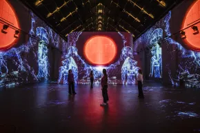 people_walking_projection_red_sun