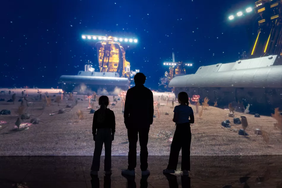 3 people standing in immersive exhibition ocean machines