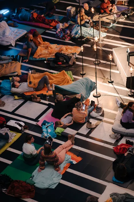 People lie on mats and listen to music